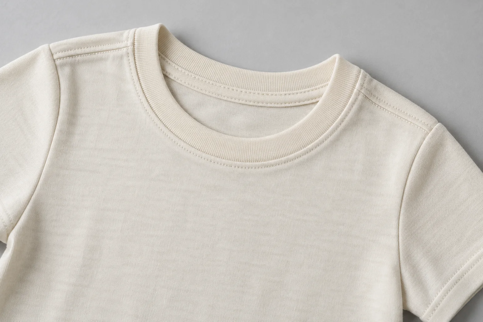 AI construction illustration of the rib neckline and shoulder seam on a cream T-shirt; not Tianyi workmanship or a sample